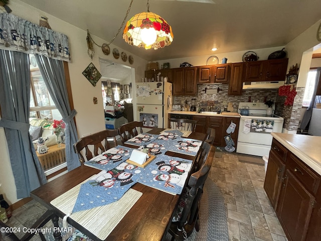 dining space featuring stone finish floor