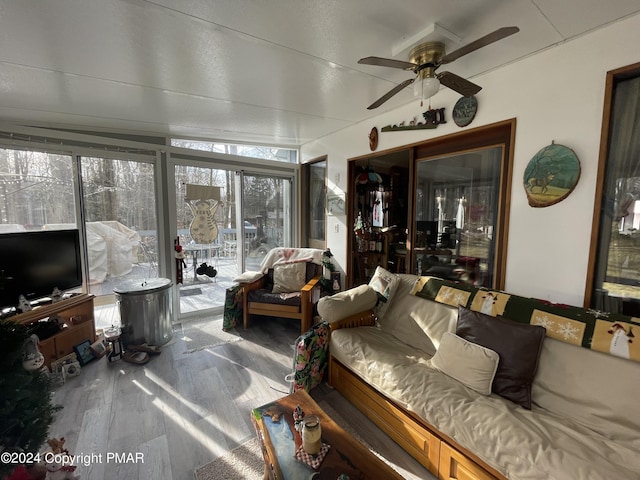 sunroom featuring a ceiling fan