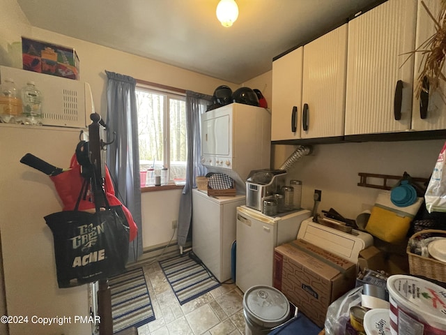 washroom with stacked washer and dryer and cabinet space