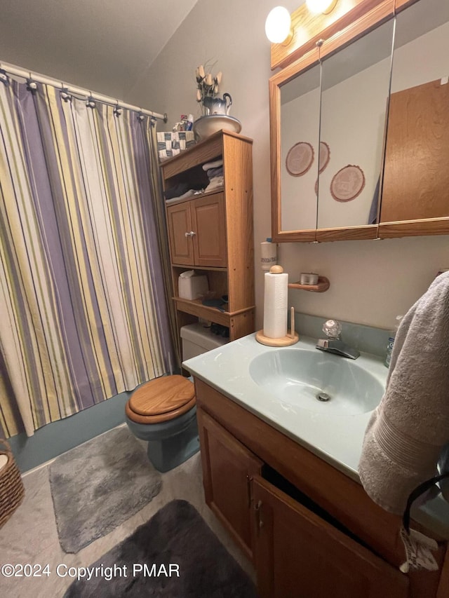 bathroom with toilet, shower / bathtub combination with curtain, and vanity