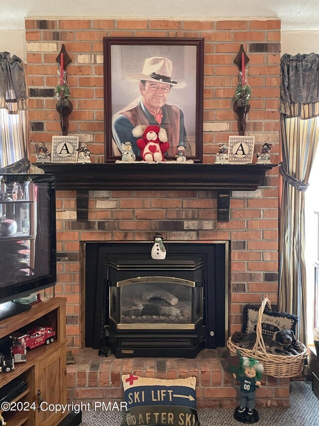 details featuring a textured ceiling and a brick fireplace