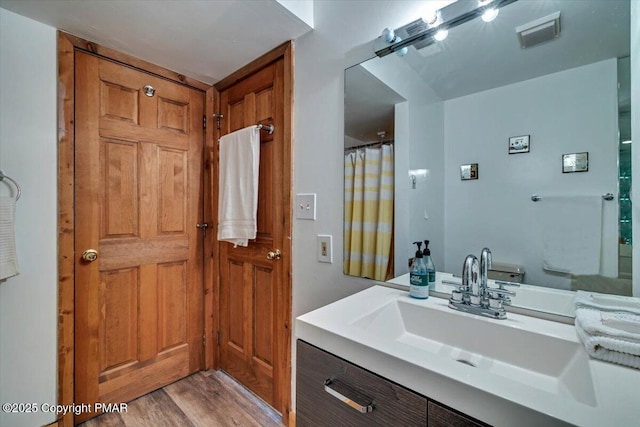 full bath with vanity, wood finished floors, and visible vents