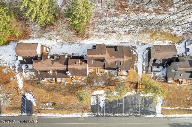 snowy aerial view with a residential view