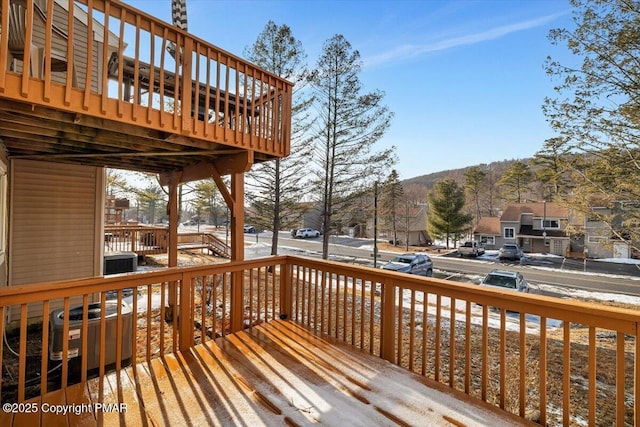 wooden deck featuring a residential view and cooling unit