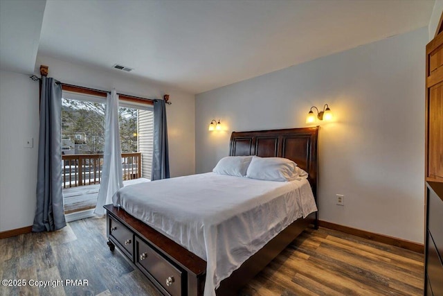 bedroom featuring dark wood-style floors, access to outside, visible vents, and baseboards