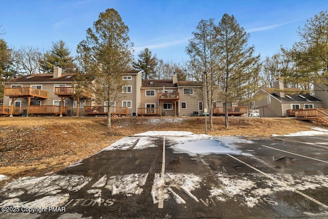 exterior space featuring uncovered parking, a residential view, and a deck