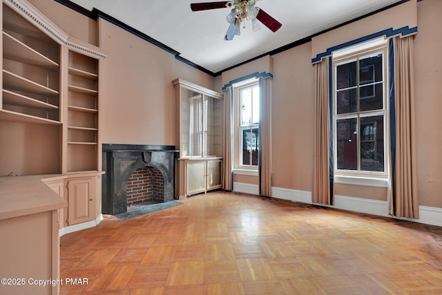 unfurnished living room with a fireplace with flush hearth, crown molding, baseboards, and a ceiling fan