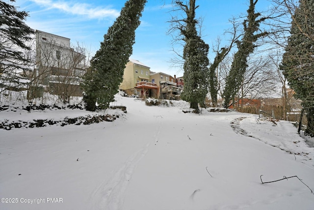 snowy yard featuring stairway