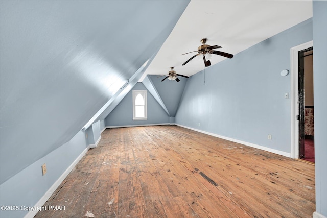 bonus room with lofted ceiling, hardwood / wood-style flooring, and baseboards