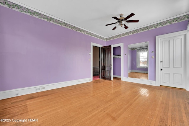 unfurnished bedroom with light wood-style floors, crown molding, baseboards, and ceiling fan