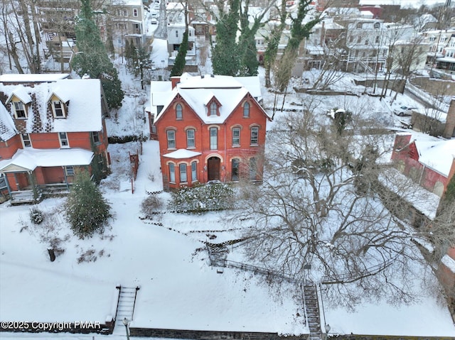 snowy aerial view with a residential view