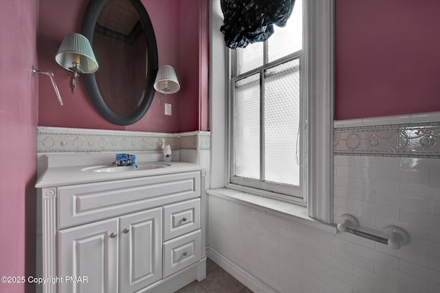 bathroom featuring a wainscoted wall, plenty of natural light, and vanity