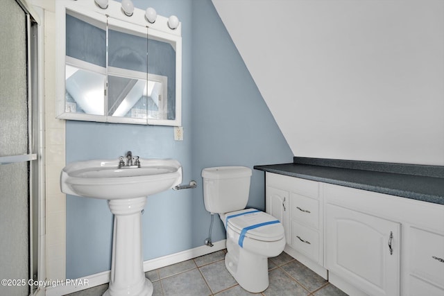 bathroom with tile patterned flooring, baseboards, toilet, and an enclosed shower