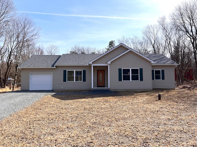 ranch-style house featuring a garage, gravel driveway, and a shingled roof