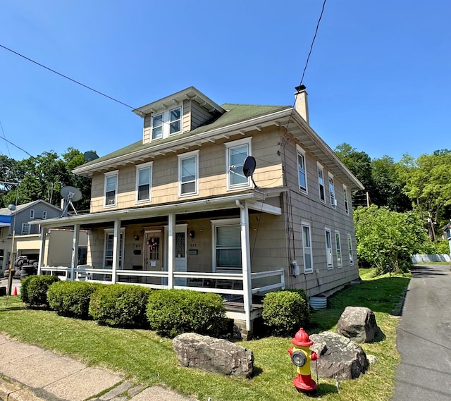 375 N Courtland St, East Stroudsburg, PA 18301 - american foursquare style home with a porch, a chimney, and a front lawn