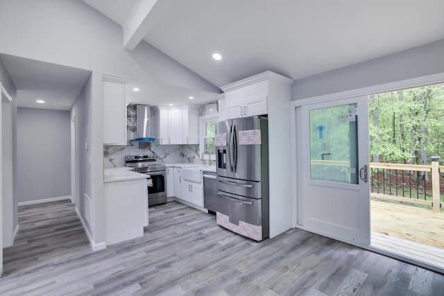 1005 Country Place Dr, Coolbaugh Township, PA 18466 - kitchen featuring stainless steel appliances, wall chimney range hood, light countertops, white cabinets, and light wood-style flooring
