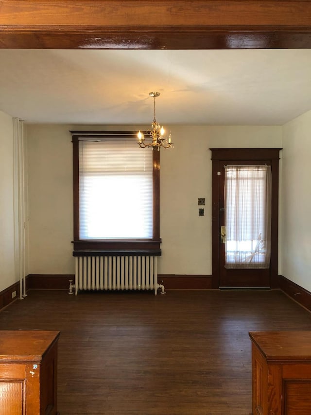 entryway featuring a notable chandelier, baseboards, radiator, and dark wood-style flooring