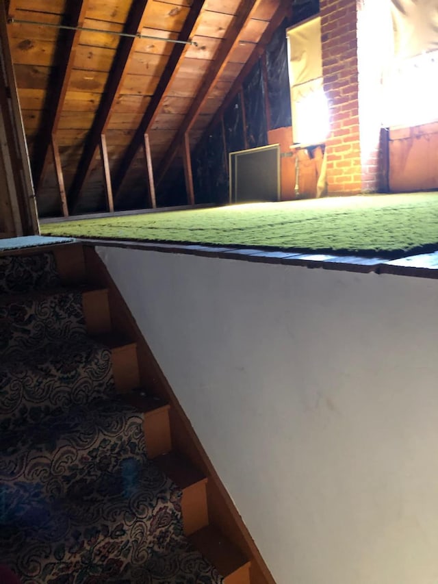 stairs with wooden ceiling and lofted ceiling with beams