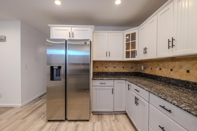 5104 Lake Dr, East Stroudsburg, PA 18301 - kitchen with stainless steel fridge, backsplash, light wood-style flooring, dark stone counters, and recessed lighting