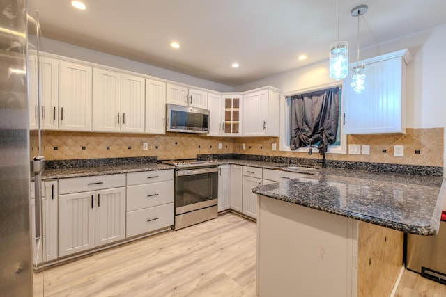 5104 Lake Dr, East Stroudsburg, PA 18301 - kitchen with stainless steel appliances, a peninsula, light wood-style floors, glass insert cabinets, and recessed lighting