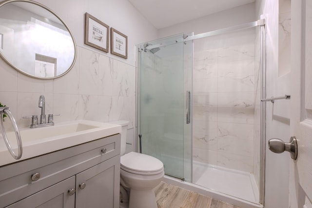 5104 Lake Dr, East Stroudsburg, PA 18301 - full bath with tile walls, a stall shower, vanity, and wood finished floors