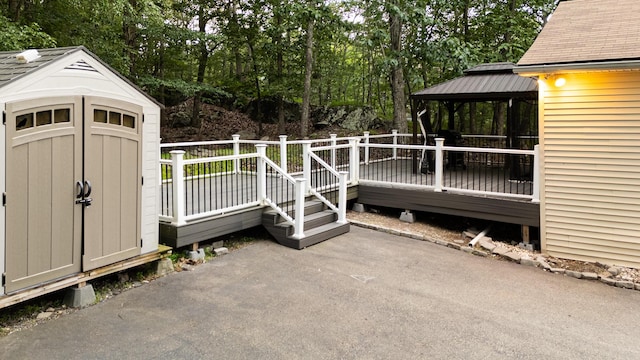 5104 Lake Dr, East Stroudsburg, PA 18301 - deck featuring a gazebo, a shed, a patio area, and view of wooded area
