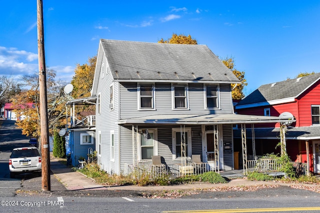 view of front of home with a porch and roof with shingles