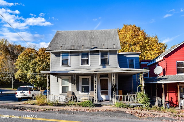 view of front of home featuring a porch and a shingled roof