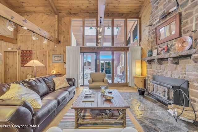 living room featuring high vaulted ceiling, wooden walls, wooden ceiling, and beam ceiling