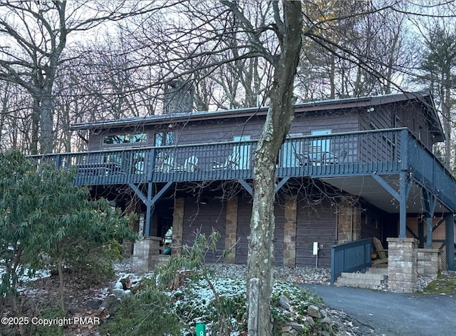 back of property with a wooden deck