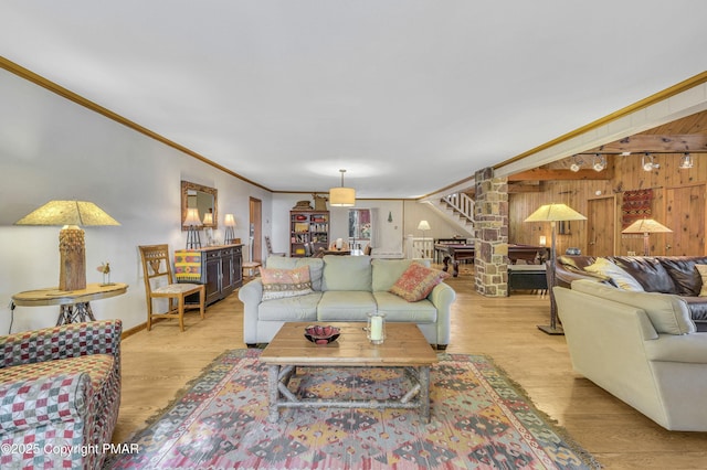 living room featuring light wood-type flooring and crown molding