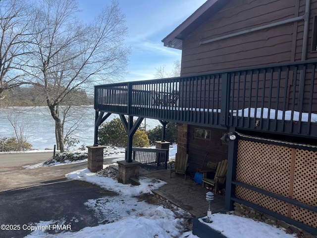 snow covered property with a deck