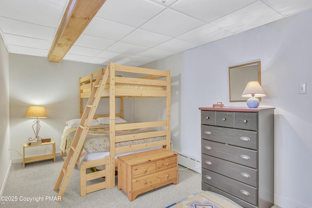 carpeted bedroom featuring a paneled ceiling