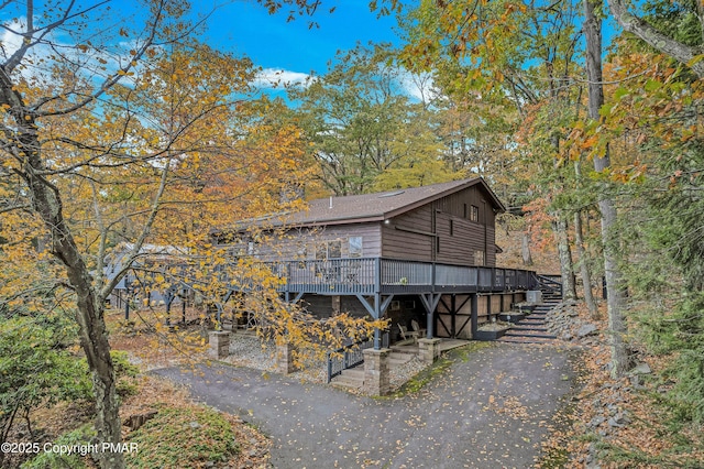 view of property exterior with a wooden deck