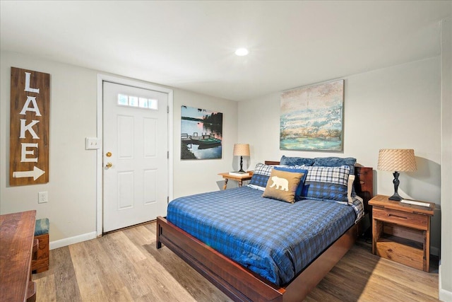 bedroom with light wood-style flooring and baseboards