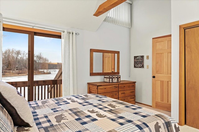 bedroom featuring baseboards and high vaulted ceiling