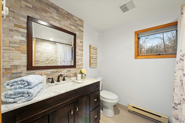 full bath with visible vents, toilet, a shower with shower curtain, baseboard heating, and vanity