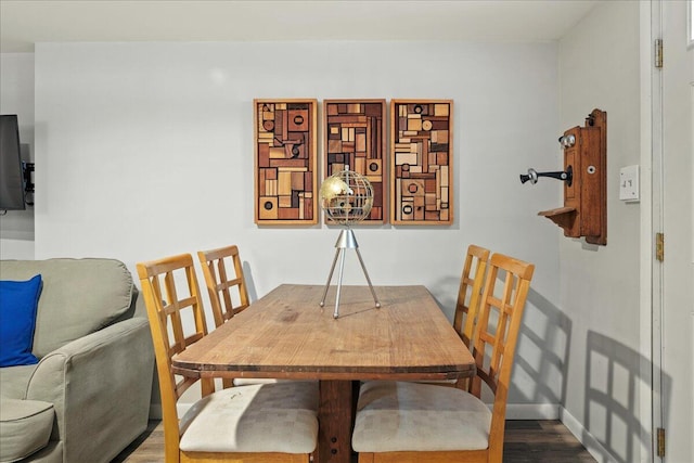 dining room featuring baseboards and wood finished floors