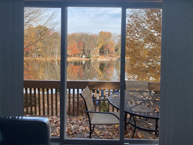 sunroom / solarium with a water view