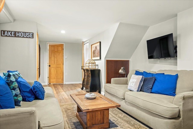 living area featuring light wood-style flooring, recessed lighting, and baseboards