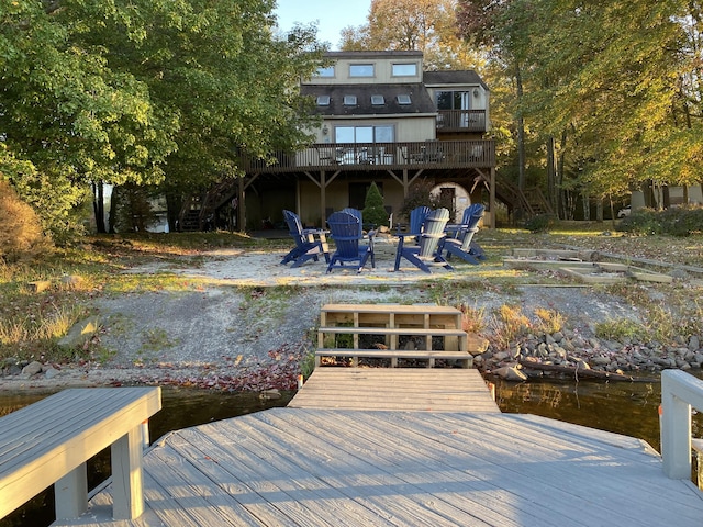 view of dock with stairs and an outdoor fire pit