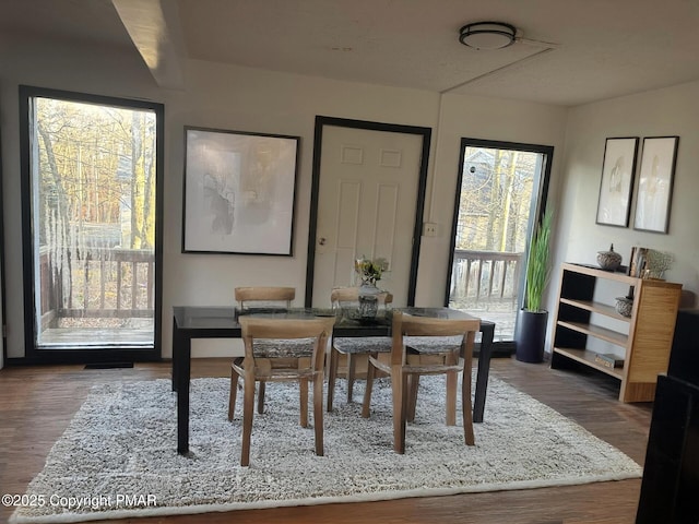 dining area featuring dark wood-type flooring and visible vents