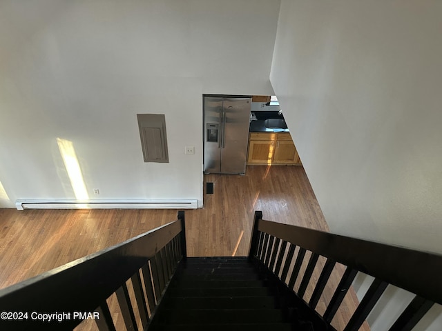 staircase featuring wood finished floors