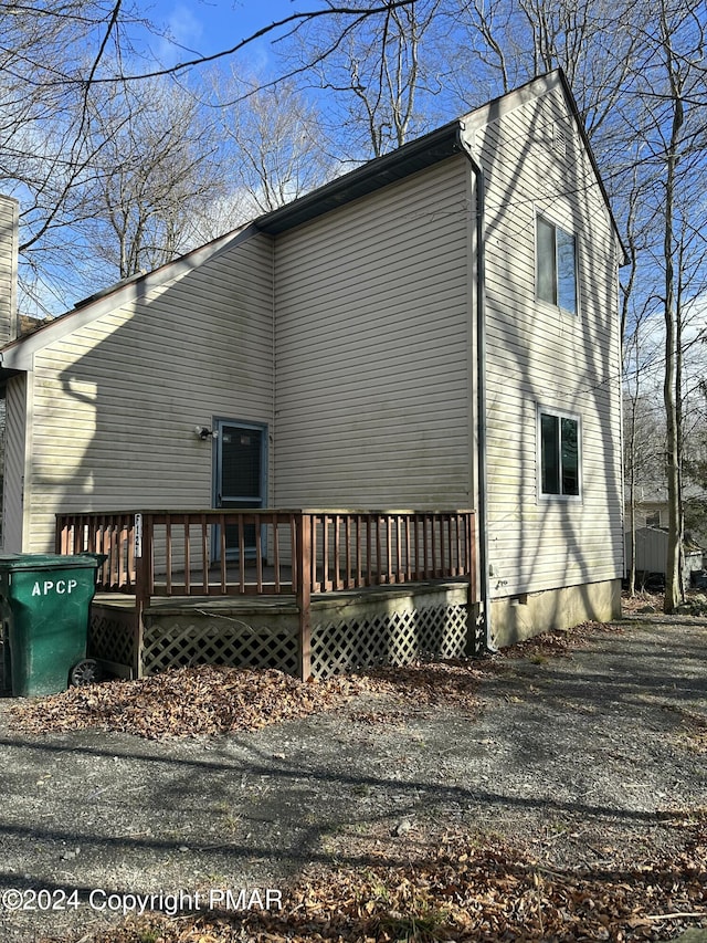 view of side of property featuring a deck