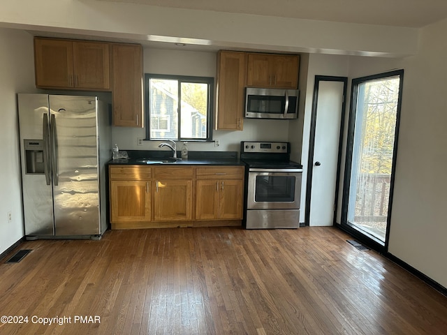 kitchen with visible vents, dark countertops, appliances with stainless steel finishes, and dark wood-style flooring