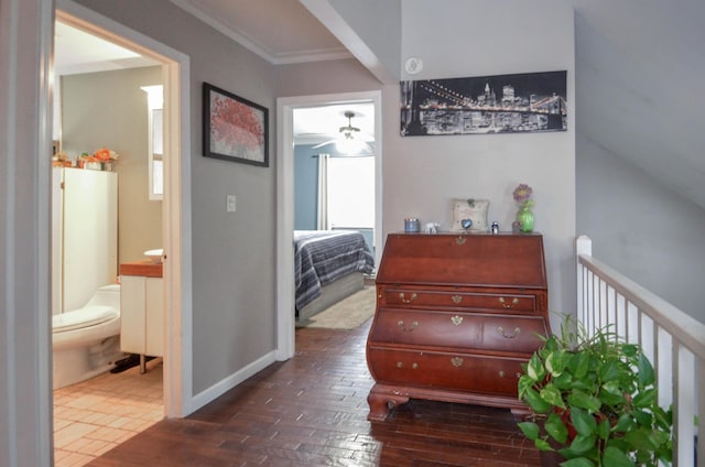 interior space featuring dark wood-style floors, ornamental molding, and baseboards