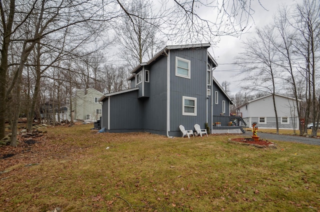 view of side of home featuring a yard