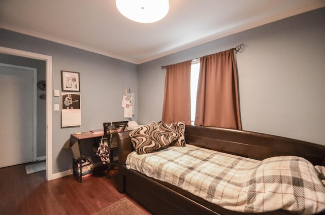 bedroom featuring baseboards, ornamental molding, and dark wood-type flooring