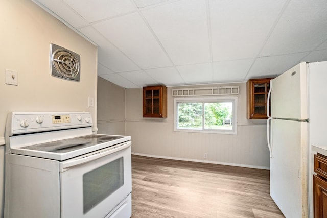 kitchen with white appliances, a paneled ceiling, light wood-style floors, baseboards, and glass insert cabinets