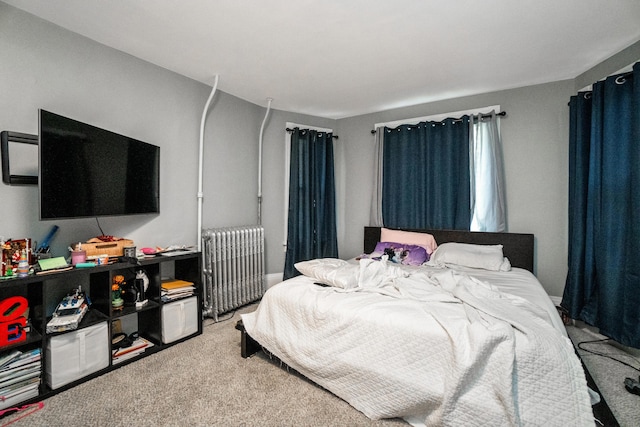 bedroom featuring radiator heating unit and carpet flooring